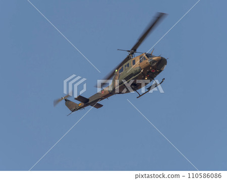 Ground Self-Defense Force helicopter flying in the blue sky 110586086