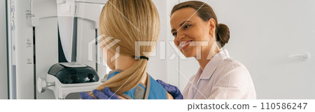 Smiling doctor prepairing woman before doing mammogram x-ray to check for breast cancer at hospital Smiling doctor prepairing woman before doing mammogram x-ray to check for breast cancer at hospital 110586247