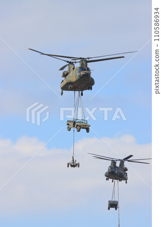 Helicopter transporting vehicles and mortars - Island recapture exercise training 110586934