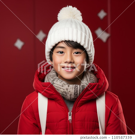 Happy asian teenage boy in a white winter hat and a red coat. Portrait of a teenager kid in a winter cap smiling on a red background looking at the camera. Cheerful Japanese teen in pom pom hat. Happy asian teenage boy in a white winter hat and a red coat. Portrait of a teenager kid in a winter cap smiling on a red background looking at the camera. Cheerful Japanese teen in pom pom hat. 110587339