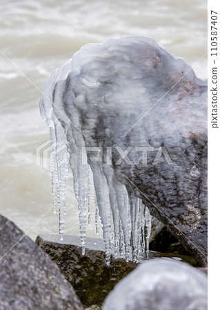 Icicles on the frozen stone on Lake Balaton of Hungary 110587407