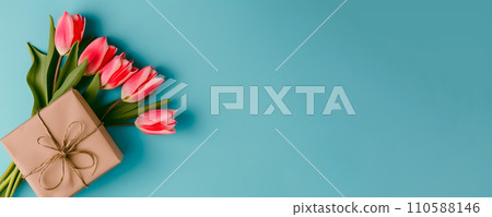AI-generated content. Mother's day concept - fresh beautiful tulips and present on solid color background 110588146