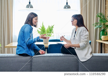 Happy young woman patient talking to female psychologist at therapy 110588290