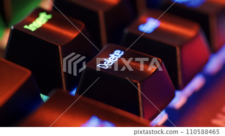 Keyboard key  - Delete - macro shot.  Modern gaming keyboard close-up with beautiful color backlight.  Macro shooting of the rgb computer keyboard with backlight.  Low angle view with soft focus. 110588465