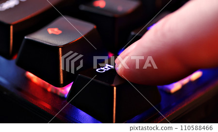 Human finger clicks on the control key on the computer keyboard, close up view. Man finger presses control on the keyboard key, macro shot. Rgb led light keyboard Human finger clicks on the control key on the computer keyboard, close up view. Man finger presses control on the keyboard key, macro shot. Rgb led light keyboard 110588466