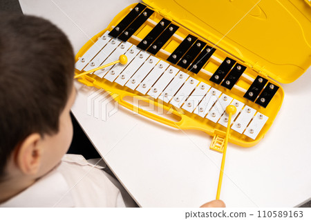 Little Six Year Old Boy Playing Metallophone Metal Xylophone Percussion Musical Instrument. 110589163