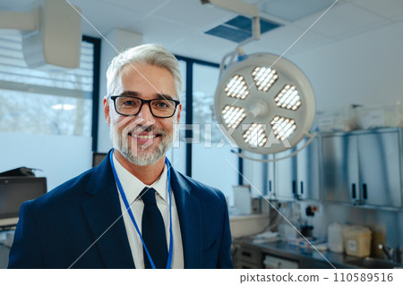 Portrait of pharmaceutical sales representative in medical building, waiting for doctor, presenting new pharmaceutical product. Hospital director, manger in private medical clinic. 110589516
