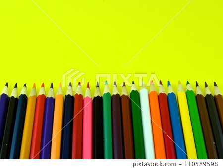 colored pencils on a yellow background 110589598