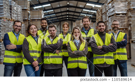 Full team of warehouse employees standing in warehouse. Team of workers, managers, female director in modern industrial factory, heavy industry, manufactrury. 110589614