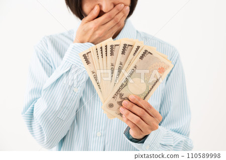 Middle-aged woman happy with bills in hand 110589998