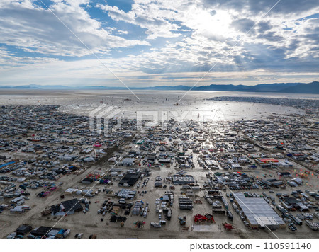 People camping in a desert during a heavy storm. Aerial shot of the camp city from above. People camping in a desert during a heavy storm. Aerial shot of the camp city from above. 110591140