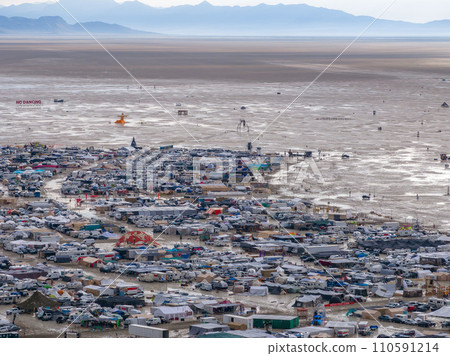 People camping in a desert during a heavy storm. Aerial shot of the camp city from above. People camping in a desert during a heavy storm. Aerial shot of the camp city from above. 110591214