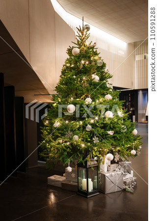 Decorated Christmas tree in a lobby with many presents under the tree. Christmas mood and spirit.  110591288