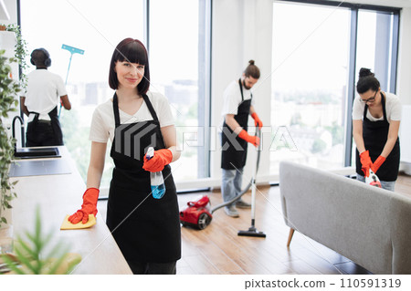 Cleaning service team at work in kitchen in private home. 110591319