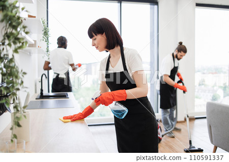 Housekeeper team in uniform apron cleaning service team at home Housekeeper team in uniform apron cleaning service team at home 110591337