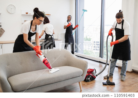 Focus on positive African American worker cleaning panoramic window. 110591403