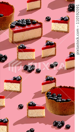 Food photo. Cheesecake with strawberry jam and blueberries with hard shadows. sweet concept pattern on pink vertical 110592091