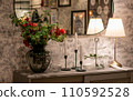 Image of Comfy cosy autumnal desk aesthetic room with vintage antique lamp, vase and mirror in metal cover 110592528