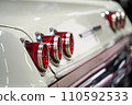 Image of Taillight of an old classic American car, three red round back lights on a white car 110592533