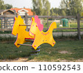 Image of Children's wooden spring horse on the playground 110592543