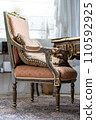 Image of Old antique vintage wooden chair with pillow in pastel colours 110592925