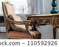 Image of Old antique vintage wooden chair with pillow in pastel colours 110592926