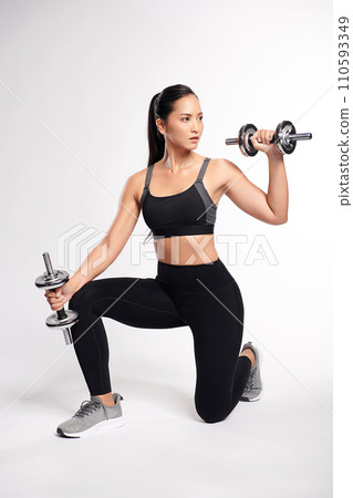 an asian woman is working out with dumbbells wearing the sport exercise suit with white background, an asian woman is working out with dumbbells wearing the sport exercise suit with white background, 110593349