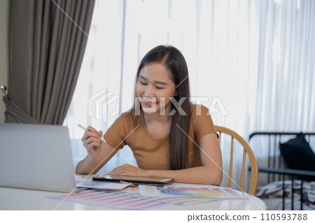 Asian woman designing clothes with laptop at home. 110593788