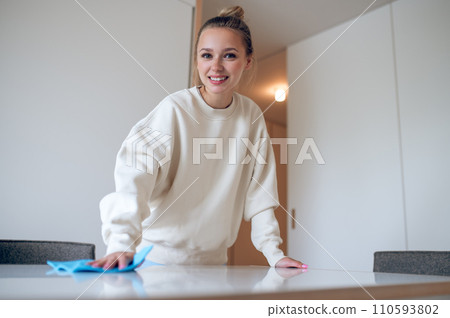 Woman wiping dust on her flat surfaces. Woman wiping dust on her flat surfaces. 110593802