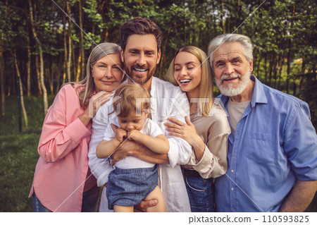 Happy family smiling and looking joyful on the nature background 110593825