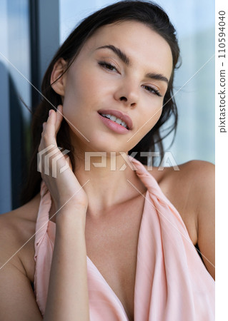 Fashion portrait of beautiful brunette woman posing in stylish evening dress, outdoor, natural daylight 110594040