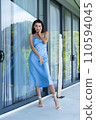 Fashion portrait of beautiful brunette woman posing in stylish evening dress, outdoor, natural daylight 110594045