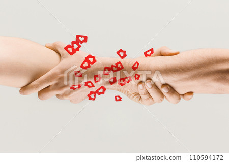 Human hands holding over many social media likes. Online popularity, influence, support, friendship 110594172