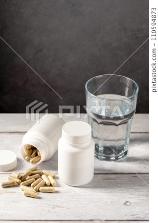 Food supplement pills in white plastic bottle. Capsules, collagen, vitamins, pain killers or drugs 110594873