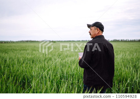 Farmer working with digital tablet for check wheat field. Agricultural growth business concept. 110594928
