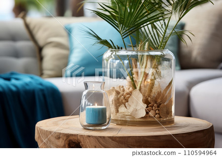 Interior decoration in a marine style, candle shells and palm leaves in glass bottles. Place to relax and read. Interior decoration in a marine style, candle shells and palm leaves in glass bottles. Place to relax and read. 110594964