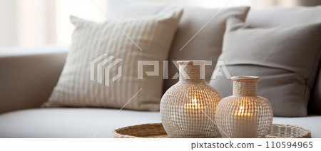 Candles and minimalist decor. Home interior in boho style, living room in pastel beige colors. Place to relax and read. 110594965