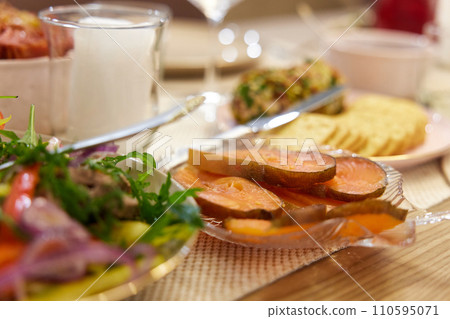 festive table with red fish. banquet table with appetizers. 110595071