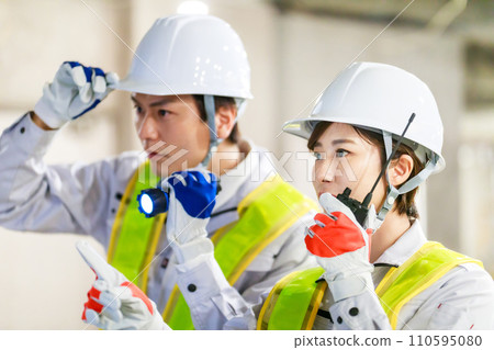 Workers using transceivers at construction sites 110595080
