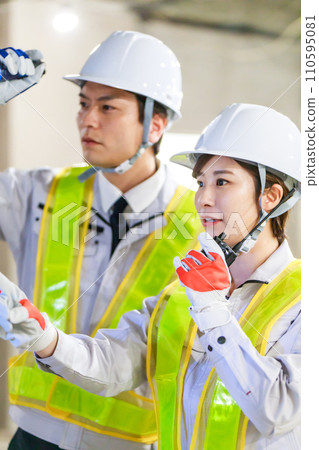 Workers using transceivers at construction sites 110595081