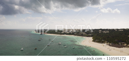 Sandy beach and green ocean in zanzibar at cloudy day 110595272