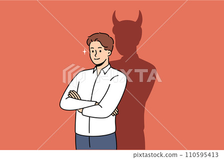 Confident businessman with bad thoughts stands with arms crossed near shadow with devil horns 110595413