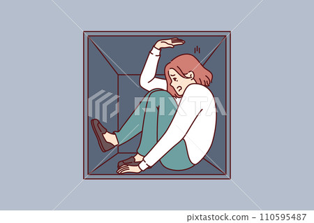 Woman suffering from claustrophobia sits in cramped box and feels pressure of walls 110595487
