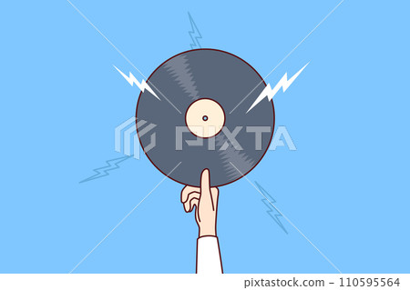 Vinyl record with retro music in hand of man offering to listen to classical composition Vinyl record with retro music in hand of man offering to listen to classical composition 110595564