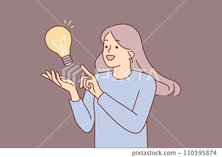 Inspired woman comes up with idea to save energy resources, stands near giant lamp Inspired woman comes up with idea to save energy resources, stands near giant lamp 110595874