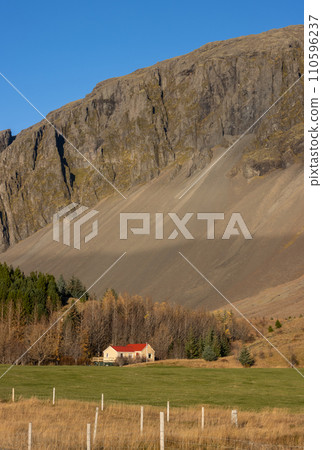 House beside a majestic mountain, East Iceland 110596237