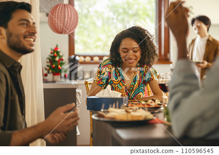 Happy friends enjoying in conversation during festive dinner at home party 110596545