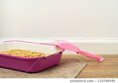 Plastic cat litter box in the bathroom 110596946