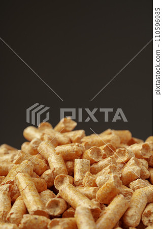 Wood pellets biofuel pile on gray background Wood pellets biofuel pile on gray background 110596985