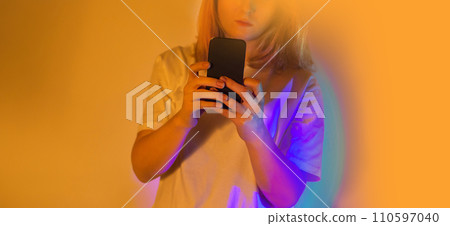 Happy woman holding a smartphone and receiving a new message Happy woman holding a smartphone and receiving a new message 110597040